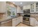 Bright kitchen with stainless steel appliances, tile backsplash, and a garden window at 312 S Hardy Dr # 106, Tempe, AZ 85281