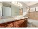 Bathroom boasting dark wood cabinets, granite counters, and a shower-tub combo at 3622 W Barcelona Dr, Chandler, AZ 85226