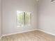 Cozy bedroom with tile floors, a large window with blinds, and neutral-colored walls at 3622 W Barcelona Dr, Chandler, AZ 85226
