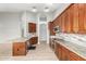 Modern kitchen featuring dark wood cabinets, granite countertops, and stainless steel appliances for cooking at 3622 W Barcelona Dr, Chandler, AZ 85226