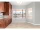 Bright kitchen nook with tile floor, granite counters, and dark wood cabinetry with backyard views at 3622 W Barcelona Dr, Chandler, AZ 85226