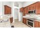 Updated kitchen features custom cabinets, granite countertops, stainless steel appliances, and tile backsplash at 3622 W Barcelona Dr, Chandler, AZ 85226