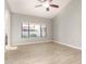 Spacious living room showcasing tile floors, large windows with blinds, and a ceiling fan at 3622 W Barcelona Dr, Chandler, AZ 85226