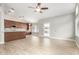 Open-concept living room featuring tile floors, a ceiling fan, and a kitchen island with granite countertops at 3622 W Barcelona Dr, Chandler, AZ 85226