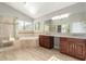 Luxurious bathroom featuring dual vanities, granite countertops, a soaking tub, and a glass-enclosed shower at 3622 W Barcelona Dr, Chandler, AZ 85226