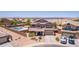 Stunning aerial view of a two story home, lake, desert landscaping and a pool at 36645 W Bilbao St, Maricopa, AZ 85138