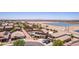 A long aerial shot captures several desert homes and a large neighborhood lake in the background at 36645 W Bilbao St, Maricopa, AZ 85138