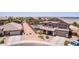Great aerial view of a home with desert landscaping, a pool and spa, and a three car garage at 36645 W Bilbao St, Maricopa, AZ 85138