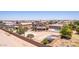 Expansive backyard featuring bocce ball court, sport court, putting green, and covered patio with pool in a desert community at 36645 W Bilbao St, Maricopa, AZ 85138