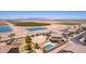 Gorgeous aerial view of a backyard oasis with a pool, desert landscaping, sport court and neighborhood views at 36645 W Bilbao St, Maricopa, AZ 85138