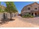 A spacious side yard featuring gravel landscaping, block fence and access to the covered patio at 36645 W Bilbao St, Maricopa, AZ 85138