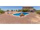 Large backyard with a stunning pool, beautiful rocks, and ample space for outdoor activities and entertaining at 36645 W Bilbao St, Maricopa, AZ 85138