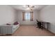 Spacious bedroom with carpet, a ceiling fan, and a sunny window with light-filtering curtains at 36645 W Bilbao St, Maricopa, AZ 85138