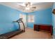 Bedroom features blue walls, carpet and a treadmill at 36645 W Bilbao St, Maricopa, AZ 85138