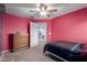 Bedroom features red walls, carpet and wooden dresser at 36645 W Bilbao St, Maricopa, AZ 85138