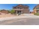 Two-story home featuring desert landscaping, a two-car garage and a neutral color scheme at 36645 W Bilbao St, Maricopa, AZ 85138