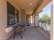 Charming front porch with a decorative bench and wrought iron railing at 36645 W Bilbao St, Maricopa, AZ 85138