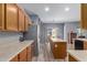 A well-appointed kitchen featuring wood cabinets, stainless steel appliances, and a center island at 36645 W Bilbao St, Maricopa, AZ 85138