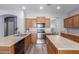 A well-appointed kitchen featuring wood cabinets, stainless steel appliances, and a center island at 36645 W Bilbao St, Maricopa, AZ 85138