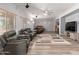 Spacious living room with comfortable seating, ceiling fan, and lots of natural light at 36645 W Bilbao St, Maricopa, AZ 85138