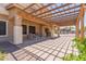Covered patio with a pergola, offering a shaded outdoor seating area and lovely views of the pool at 36645 W Bilbao St, Maricopa, AZ 85138