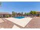 Backyard showcasing a sparkling blue pool, surrounded by a spacious patio and desert landscaping at 36645 W Bilbao St, Maricopa, AZ 85138