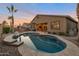 A stunning backyard featuring a pool, a covered patio, and well-maintained landscaping creating a serene retreat at 3907 E Carob Dr, Gilbert, AZ 85298