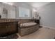 Bathroom features a sleek soaking tub, dark vanities, and tiled accents around the tub and large mirrors at 3907 E Carob Dr, Gilbert, AZ 85298
