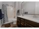 Well-lit bathroom features a shower with a tub, a toilet, and a double sink vanity with a large mirror at 3907 E Carob Dr, Gilbert, AZ 85298