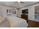 Bright bedroom features a tray ceiling, carpet, ceiling fan, and large bed. Large dresser under tv at 3907 E Carob Dr, Gilbert, AZ 85298