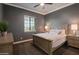 Cozy bedroom with a queen bed, side tables, and window, perfect for relaxation at 3907 E Carob Dr, Gilbert, AZ 85298