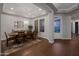 Formal dining room features tray ceiling, hardwood floors, and an elegant chandelier over a large wooden table with seating at 3907 E Carob Dr, Gilbert, AZ 85298