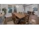 Spacious dining room features dark wood floors and an expansive wooden table surrounded by chairs, complemented by a modern light fixture at 3907 E Carob Dr, Gilbert, AZ 85298