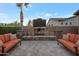 The outdoor living space features a cozy stone fireplace and comfortable seating for relaxing evenings at 3907 E Carob Dr, Gilbert, AZ 85298