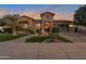 Beautiful front exterior of home features stone accents, manicured landscaping, and a welcoming entrance with a well-lit walkway at 3907 E Carob Dr, Gilbert, AZ 85298