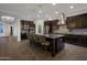 View of a modern kitchen with stainless steel appliances, tile backsplash, granite counters and an island with seating at 3907 E Carob Dr, Gilbert, AZ 85298