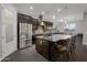 Beautiful kitchen with stainless steel appliances, granite counters, tile backsplash and an island with seating at 3907 E Carob Dr, Gilbert, AZ 85298