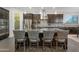 Modern kitchen with dark cabinets, granite countertops, stainless steel appliances, and a central island with seating at 3907 E Carob Dr, Gilbert, AZ 85298