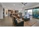 Open living area with leather seating, ceiling fan, and sliding glass doors to the patio, offering a view of the outdoor space at 3907 E Carob Dr, Gilbert, AZ 85298