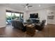 Comfortable living room with reclining chairs, tiled floor, and a view of the backyard, creating a relaxing and inviting space at 3907 E Carob Dr, Gilbert, AZ 85298