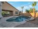 An inviting backyard pool is surrounded by stone pavers and lush landscaping, creating a private oasis at 3907 E Carob Dr, Gilbert, AZ 85298