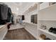 Spacious walk-in closet with custom shelving, hanging rods, and carpet flooring provides ample storage at 3907 E Carob Dr, Gilbert, AZ 85298