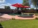Relaxing backyard featuring a private pool, rock waterfall, and well-manicured lawn at 45722 W Barbara Ln, Maricopa, AZ 85139