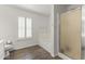 Bright bathroom showcasing wood floors, separate tub, and glass shower at 45722 W Barbara Ln, Maricopa, AZ 85139