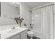 Bright bathroom featuring a vanity with sink, tub, toilet, and shower curtain at 45722 W Barbara Ln, Maricopa, AZ 85139