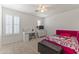 Bright bedroom featuring white shutters, a ceiling fan, and a playful Hello Kitty themed bed at 45722 W Barbara Ln, Maricopa, AZ 85139