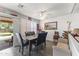Elegant dining area with stylish seating, bright natural light, and access to the outdoor pool at 45722 W Barbara Ln, Maricopa, AZ 85139