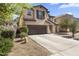 Inviting curb appeal showcasing a two-story home with desert landscaping and spacious driveway at 45722 W Barbara Ln, Maricopa, AZ 85139