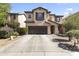 Two-story home featuring a spacious driveway, desert landscaping, and a neutral-toned stucco facade at 45722 W Barbara Ln, Maricopa, AZ 85139