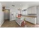 Bright kitchen featuring white cabinets, an island, and modern appliances at 45722 W Barbara Ln, Maricopa, AZ 85139